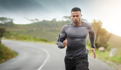 Wall Mural - Get to your goals. Shot of a sporty young man running outdoors.