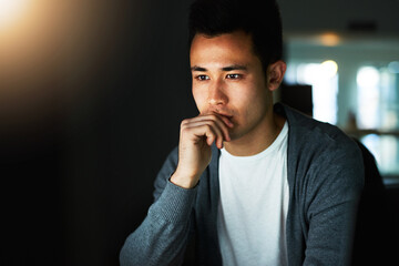 Sticker - Working through the night. Shot of a handsome young male programmer working late in his office.