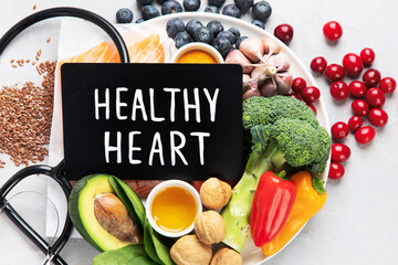 Wall Mural - Foods for healthy heart on light background.