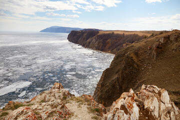 Lake Baikal in the spring. White ice floes melt on the water. North of Olkhon Island, Cape Khoboy.