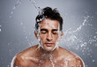 © Jeff Bergen/peopleimages.com - Getting clean. A young man splashing water on his face.
