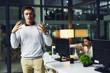 Poster - So heres what you need to do.... Shot of a young call centre agent working late in an office.