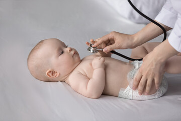 cropped professional female medical worker pediatrician nurse using stethoscope, listening lungs or 