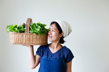 woman holding a basket of vegetables