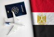 Flag of Egypt with passport and toy airplane. Flight travel concept
