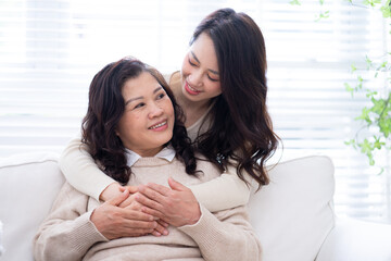 Image of Asian mother and daughter at home