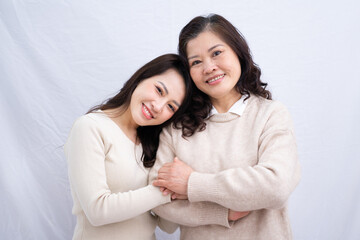 portrait of asian mother and daughter on white background