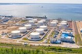 Fototapeta Przestrzenne - Business commercial trade fuel and energy transport by tanker vessel. Aerial view storage tank farm at night, Tank farm storage chemical petroleum petrochemical refinery product at oil terminal.