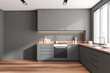 © ImageFlow - Front view on dark kitchen interior with empty grey wall