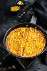 Wall Mural - Cooking of French crepe Suzette with orange sauce in a skillet. Black background. Top view
