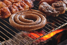 South African Braai. With Boerewors Sausage, Kebabs And Lamb Chops. Chicken Espetadas. Hot Coals In The Background 