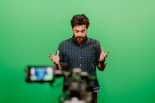 youtuber recording on green screen in studio