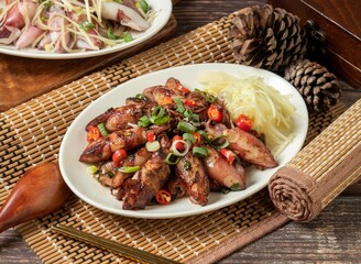 Fried rolls noodle in a dish isolated on mat side view on dark wooden table taiwan food