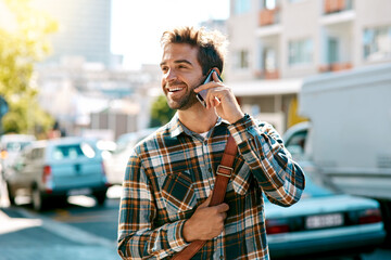 Poster - Its where you go and who you know. Shot of a handsome young man using his mobile phone while out in the city.