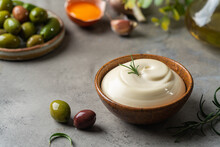 Bowl Of Homemade Mayonnaise Sauce With Olives, Ingredients And Herbs For Cooking