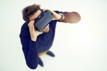 Poster - Discover more than you would ever imagine. High angle shot of a businessman wearing a VR headset in an office.