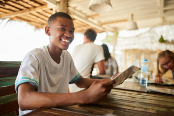 Poster - Whats on the menu. Portrait of a young man reading a menu in a restaurant.