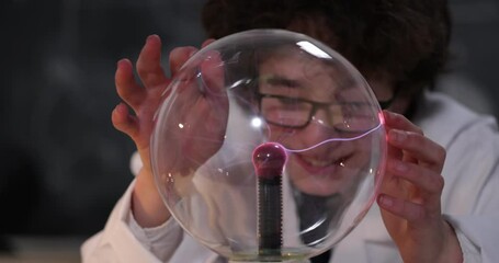 Wall Mural - schoolboy experimenting in physics class. young student doing physics experiment in the classroom.