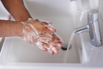Poster - Good hygiene promotes good health. Cropped shot of a man washing his hands at a bathroom.