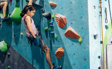 Caucasian Active Girl Playing With Happiness And Climbing Rock Mountain With Safety For Adventure And Sport. Activity And Education Concept.