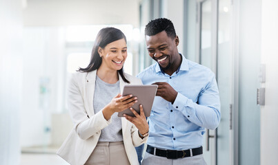 Poster - Think of your competitor as your motivation. Shot of two businesspeople discussing something on a digital tablet.