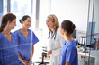 © Daniel L/peopleimages.com - Morning staff meeting. Shot of a female doctor talking to a group of nurses at a hospital.