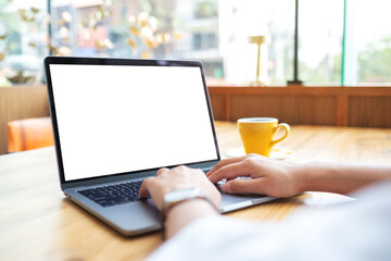 Wall Mural - mockup image of a woman using and working on laptop touchpad with blank white desktop screen
