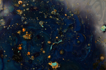 Macro Abstract bubble marble texture background. Acrylic gold and blue color in water and oil.