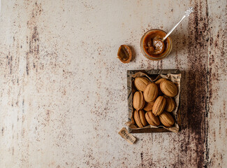 Wall Mural - cookies nuts with boiled condensed milk in a brown box