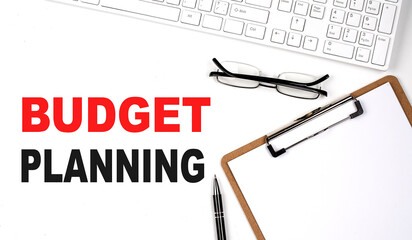 Poster - BUDGET PLANNING text written on the white background with keyboard, paper sheet and pen