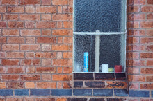 Pattern Background Image Of Frosted Window On Old Redbrick Wall With Line Of Black Bricks