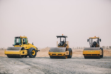 Wall Mural - Dozer, excavator, and road rollers working on the mud site