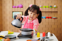 Young Girl Pretend Playing Food Preparing At Home