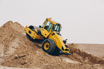 Wall Mural - Dozer, excavator, and road rollers working on the mud site