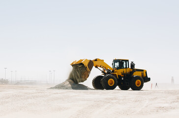 Wall Mural - Dozer, excavator, and road rollers working on the mud site