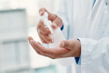 Canvas Print - For my safety and for yours. Cropped shot of a scientist disinfecting his hands with hand sanitiser in a laboratory.