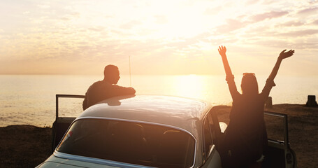 Aufkleber - Winning is what lovers do. Cropped shot of a young couple cheering at the beach while out on a road trip.