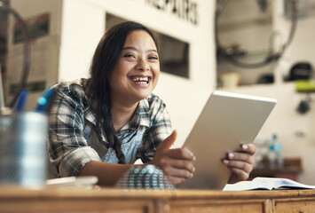 Aufkleber - An infectious smile is already half the charm. Portrait of a young woman using a digital tablet at work.