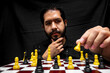 © Narayan - latin man with beard challenging in chess game, chess concept