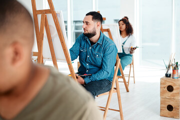 Aufkleber - Art is the last form of magic that exists. Cropped shot of a handsome young artist sitting and painting during an art class in the studio.