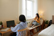 © DragonImages - Serious female college students studying in dormitory