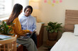 © DragonImages - Female student listening to friend explaining her idea for school project