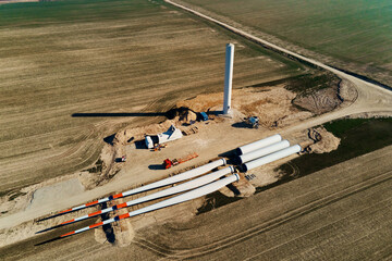 Canvas Print - Windmill generator wing prepared for assembling on ground, Construction site for wind power generator building, Green power and renewable energy