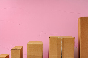 Wall Mural - Set of cardboard boxes on pink background