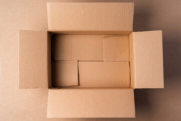 Cardboard box on beige background in studio