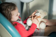 © Westend61 - Little girl sitting on dental chair with stuffed toy at medical clinic