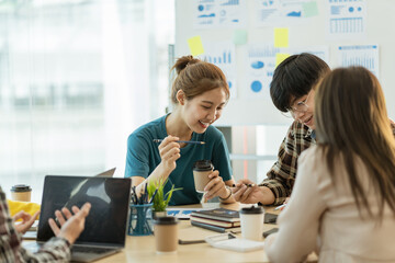 Group of young Asian business people meeting working with new startup project idea presentation analyze plan marketing and investment.