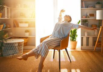 woman resting on armchair at home