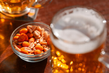 Wall Mural - Two cold draught blonde beers and some peanuts on a table. Drinking on a pub terrace with friends. Drinks and beer photography.