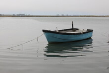 Old Small Blue Fishing Boat On Water
